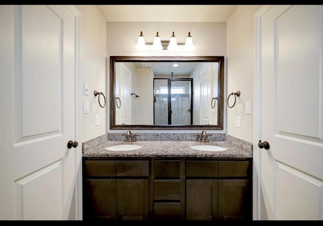 5011 Anthony Springs Ln, Sugar Land, TX 77479 - bathroom featuring double vanity and an enclosed shower
