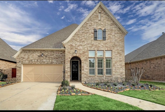 5011 Anthony Springs Ln, Sugar Land, TX 77479 - french provincial home with brick siding, an attached garage, concrete driveway, and a front lawn