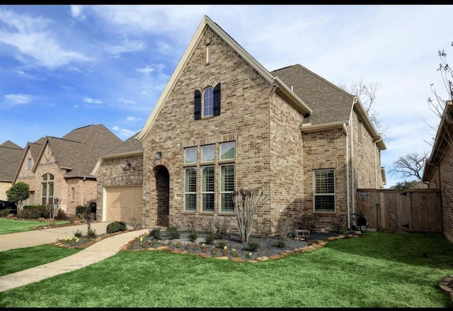 5011 Anthony Springs Ln, Sugar Land, TX 77479 - french provincial home with brick siding, driveway, a garage, and a shingled roof