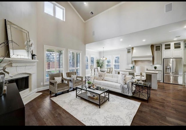 5011 Anthony Springs Ln, Sugar Land, TX 77479 - living room with ornamental molding, high vaulted ceiling, dark wood-style floors, plenty of natural light, and a premium fireplace