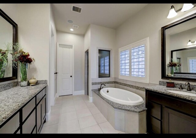 5011 Anthony Springs Ln, Sugar Land, TX 77479 - full bathroom with a bath, two vanities, plenty of natural light, and tile patterned flooring