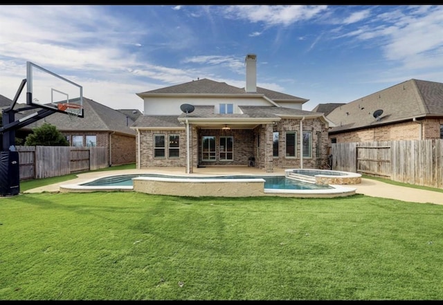 5011 Anthony Springs Ln, Sugar Land, TX 77479 - back of house with a fenced backyard, a pool with connected hot tub, a chimney, and brick siding