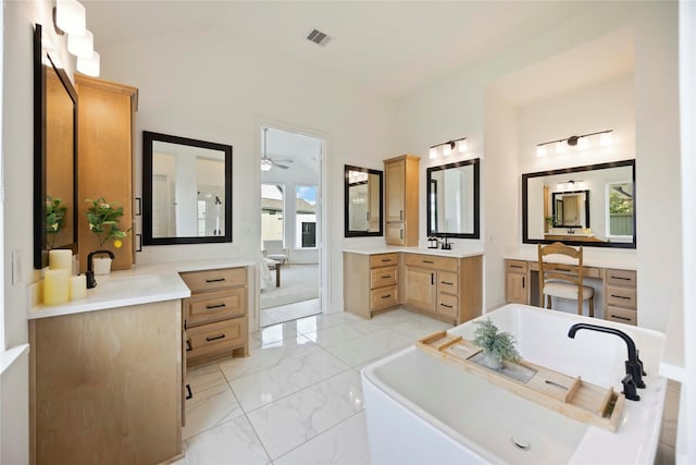 11822 Creekside Shore Cir, Cypress, TX 77433 - full bath featuring a soaking tub, two vanities, marble finish floors, and ceiling fan