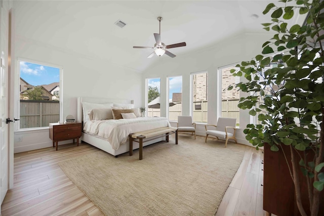 11822 Creekside Shore Cir, Cypress, TX 77433 - bedroom with light wood finished floors, vaulted ceiling, and a ceiling fan