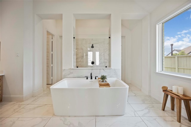 11822 Creekside Shore Cir, Cypress, TX 77433 - bathroom featuring marble finish floors, a freestanding tub, and vanity
