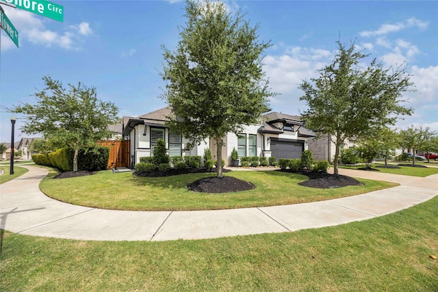 11822 Creekside Shore Cir, Cypress, TX 77433 - view of property hidden behind natural elements with a garage and concrete driveway