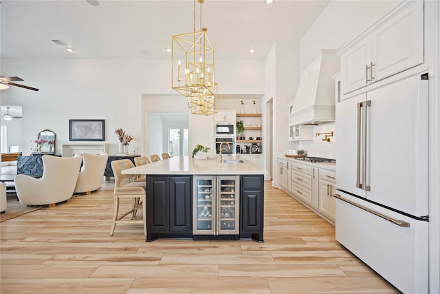 11822 Creekside Shore Cir, Cypress, TX 77433 - kitchen with appliances with stainless steel finishes, beverage cooler, a chandelier, white cabinetry, and a ceiling fan