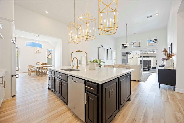 11822 Creekside Shore Cir, Cypress, TX 77433 - kitchen with dishwasher, light wood-style floors, a chandelier, light countertops, and ceiling fan