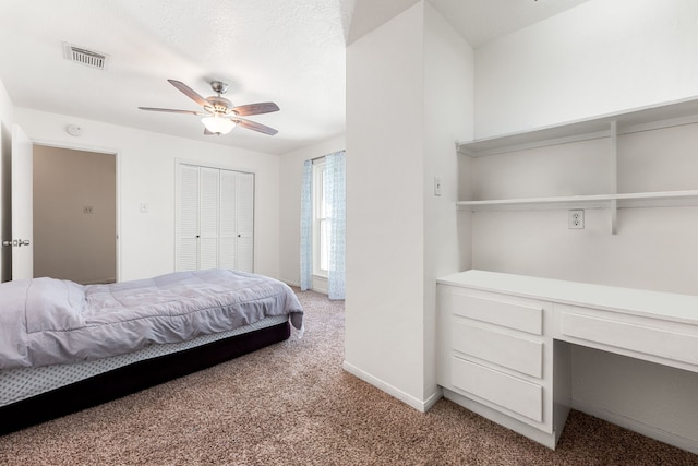 7306 Creek Crest Dr, Houston, TX 77095 - bedroom featuring light carpet, built in desk, a ceiling fan, and a closet