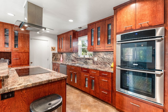 7306 Creek Crest Dr, Houston, TX 77095 - kitchen featuring stainless steel appliances, island exhaust hood, tasteful backsplash, light stone counters, and glass insert cabinets