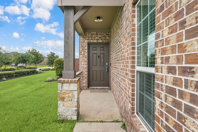 14722 Ruddy Duck Ln, Houston, TX 77049 - doorway to property featuring brick siding and a yard