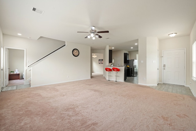 14722 Ruddy Duck Ln, Houston, TX 77049 - unfurnished living room featuring ceiling fan, light carpet, stairway, and recessed lighting