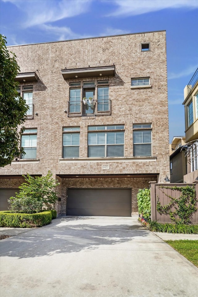 1422 Rosedale St, Houston, TX 77004 - townhome / multi-family property featuring concrete driveway, an attached garage, and brick siding
