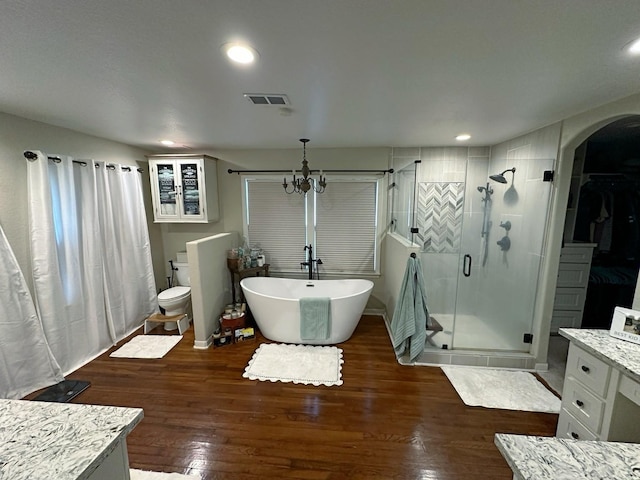 2201 Oleander Dr, Dickinson, TX 77539 - full bath featuring a shower stall, a freestanding tub, hardwood / wood-style flooring, recessed lighting, and vanity
