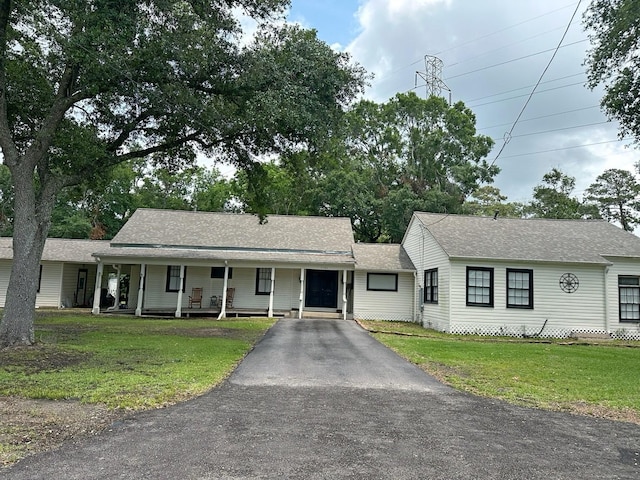 2201 Oleander Dr, Dickinson, TX 77539 - view of front of home with driveway, a porch, a front yard, and a shingled roof