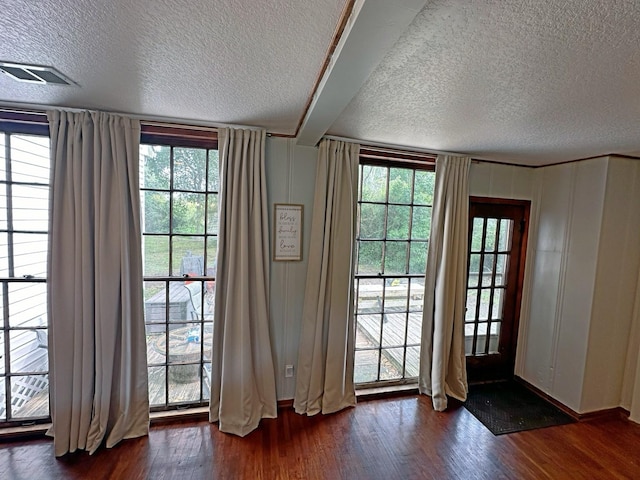2201 Oleander Dr, Dickinson, TX 77539 - doorway with a textured ceiling and dark wood finished floors