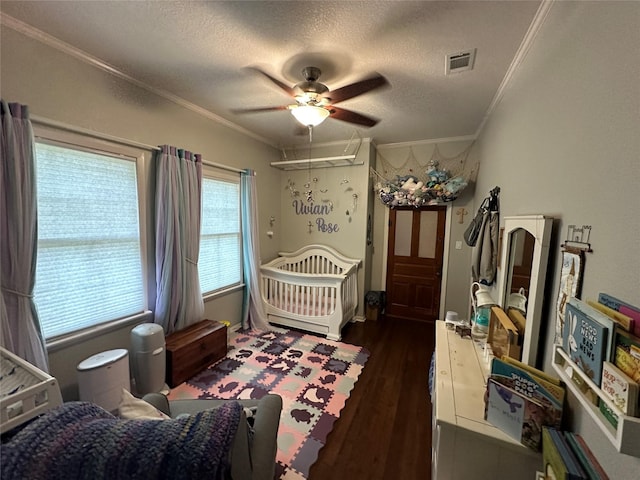 2201 Oleander Dr, Dickinson, TX 77539 - bedroom featuring ornamental molding, dark wood-style floors, a textured ceiling, and a ceiling fan