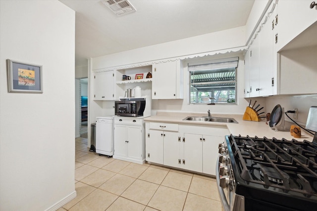 2110 Chippendale Rd, Houston, TX 77018 - kitchen with stainless steel appliances, light countertops, light tile patterned floors, open shelves, and white cabinetry