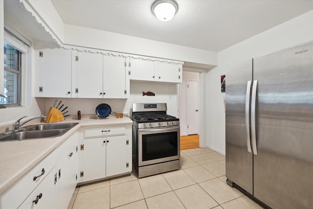 2110 Chippendale Rd, Houston, TX 77018 - kitchen featuring stainless steel appliances, white cabinets, light countertops, and light tile patterned floors