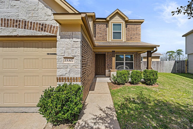 15307 Meandering Post Trl, Houston, TX 77044 - view of front of house with brick siding, covered porch, and an attached garage