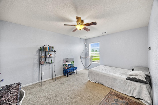 15307 Meandering Post Trl, Houston, TX 77044 - carpeted bedroom with a ceiling fan, a textured ceiling, and a textured wall