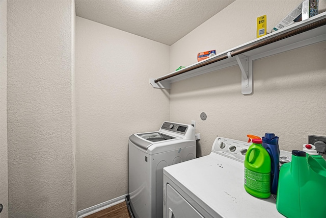 15307 Meandering Post Trl, Houston, TX 77044 - washroom featuring washing machine and dryer, a textured ceiling, dark wood-style floors, and a textured wall