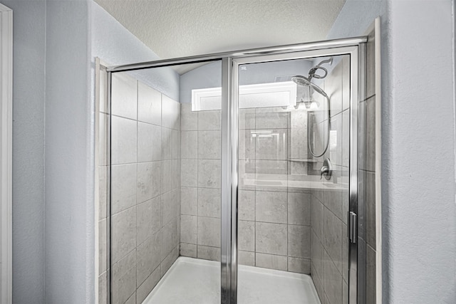 15307 Meandering Post Trl, Houston, TX 77044 - full bath featuring a textured wall, a stall shower, and a textured ceiling