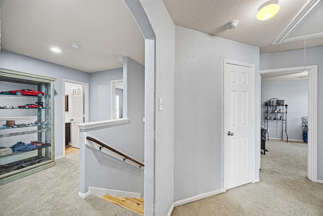 15307 Meandering Post Trl, Houston, TX 77044 - corridor featuring attic access, an upstairs landing, carpet flooring, arched walkways, and a textured wall