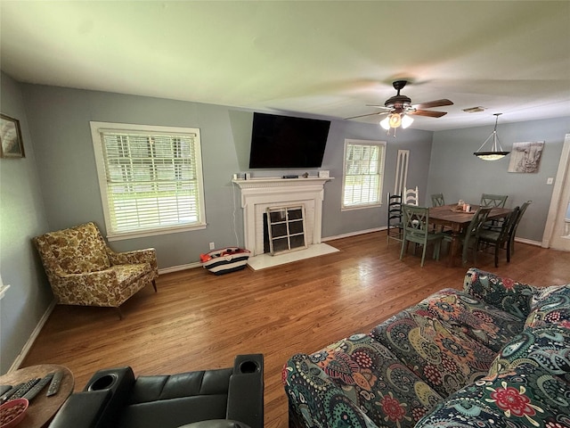 132 Daisy St, Lake Jackson, TX 77566 - living room with a ceiling fan, wood finished floors, and a fireplace with flush hearth