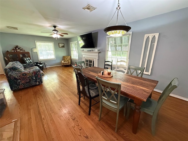 132 Daisy St, Lake Jackson, TX 77566 - dining space with a fireplace, wood finished floors, and a ceiling fan