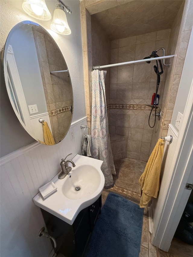 132 Daisy St, Lake Jackson, TX 77566 - bathroom with vanity, a stall shower, and a wainscoted wall