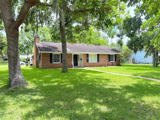 132 Daisy St, Lake Jackson, TX 77566 - ranch-style home with a chimney, a front yard, brick siding, and a shingled roof