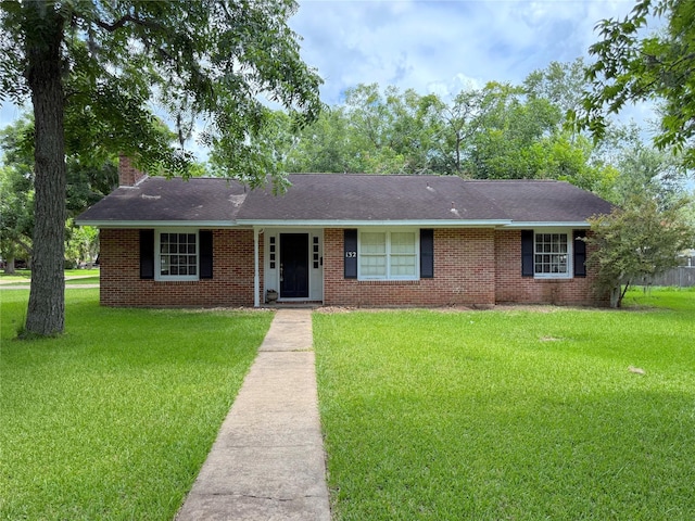 132 Daisy St, Lake Jackson, TX 77566 - ranch-style home featuring a chimney, a front yard, and brick siding
