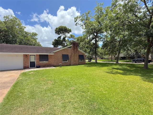 132 Daisy St, Lake Jackson, TX 77566 - view of front of home featuring a garage, driveway, a chimney, a front yard, and brick siding