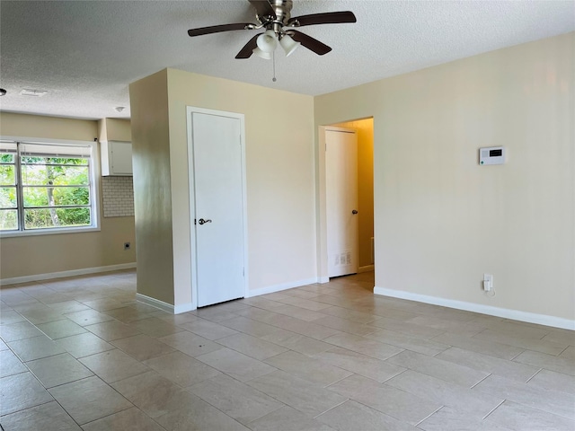 300 Robbie St, La Marque, TX 77568 - spare room featuring a textured ceiling, ceiling fan, and light tile patterned floors