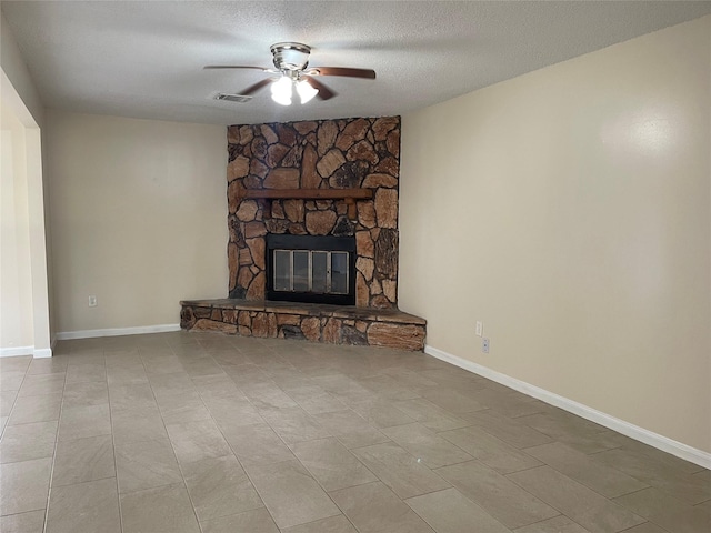 300 Robbie St, La Marque, TX 77568 - unfurnished living room featuring a ceiling fan, a fireplace, and a textured ceiling