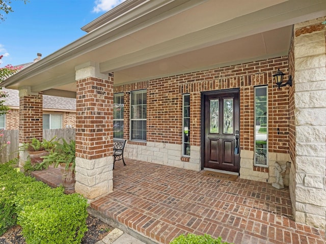 3310 Compass Ct, Conroe, TX 77301 - doorway to property featuring brick siding and a porch