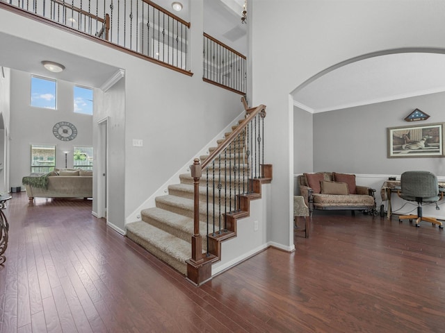 3310 Compass Ct, Conroe, TX 77301 - stairs with a towering ceiling, arched walkways, wood finished floors, and ornamental molding