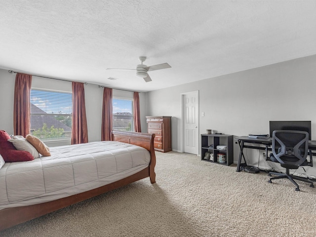 3310 Compass Ct, Conroe, TX 77301 - bedroom with carpet floors, a textured ceiling, a desk, and ceiling fan