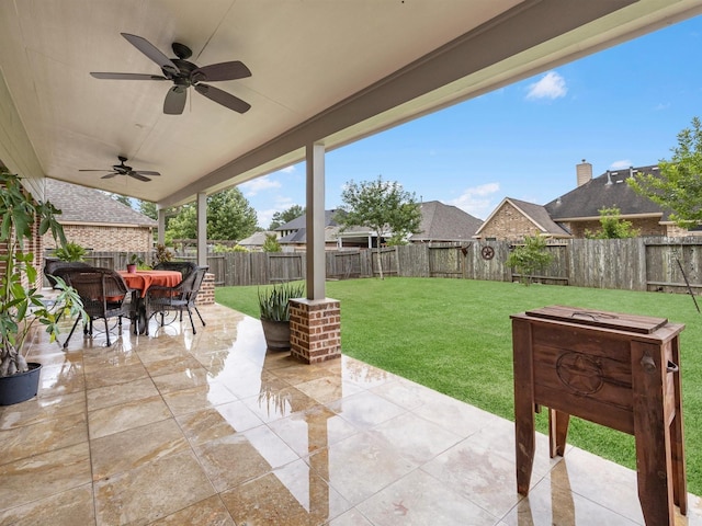 3310 Compass Ct, Conroe, TX 77301 - fenced backyard featuring a patio, a ceiling fan, and outdoor dining area