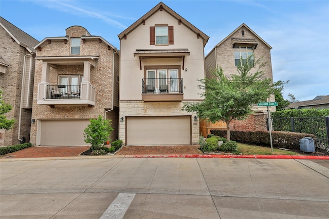 1002 Shepherd Oaks Dr, Houston, TX 77018 - view of front of home featuring decorative driveway, stucco siding, an attached garage, and a balcony