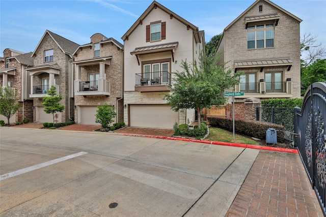 1002 Shepherd Oaks Dr, Houston, TX 77018 - view of front of house featuring an attached garage, concrete driveway, a balcony, a standing seam roof, and french doors