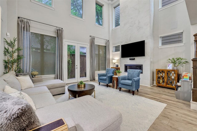 1002 Shepherd Oaks Dr, Houston, TX 77018 - living area featuring a high ceiling, french doors, wood finished floors, and a fireplace