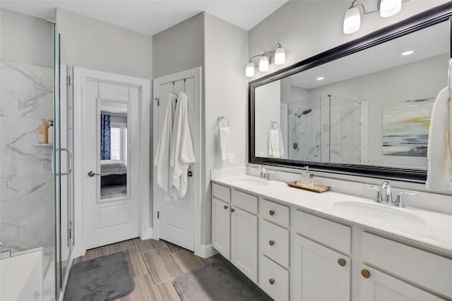1002 Shepherd Oaks Dr, Houston, TX 77018 - full bath featuring a marble finish shower, double vanity, and wood tiled floors