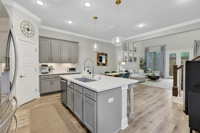 1002 Shepherd Oaks Dr, Houston, TX 77018 - kitchen featuring gray cabinets, appliances with stainless steel finishes, light wood finished floors, recessed lighting, and ornamental molding