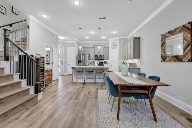 1002 Shepherd Oaks Dr, Houston, TX 77018 - dining room with ornamental molding, stairs, light wood finished floors, and recessed lighting