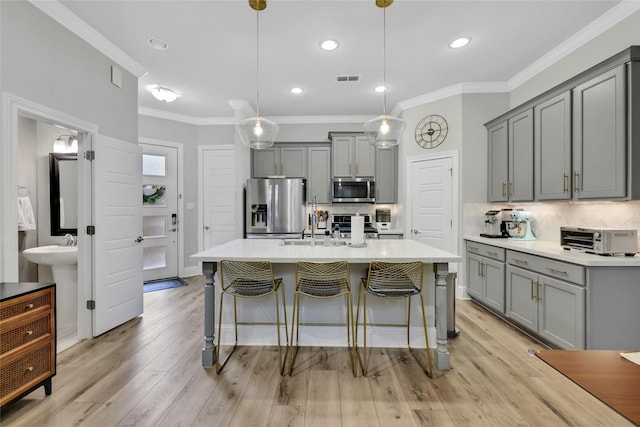 1002 Shepherd Oaks Dr, Houston, TX 77018 - kitchen with gray cabinetry, stainless steel appliances, tasteful backsplash, ornamental molding, and light countertops