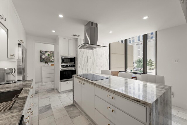 5555 Del Monte Dr Unit T24, Houston, TX 77056 - kitchen with island range hood, stainless steel appliances, recessed lighting, white cabinetry, and light stone countertops
