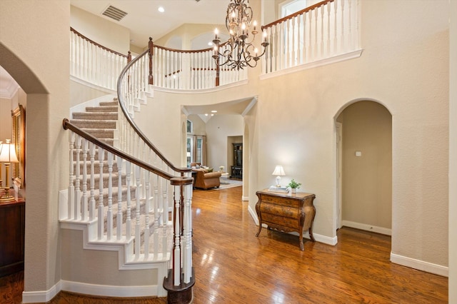 5222 Arcadia Glen Ln, Katy, TX 77494 - foyer featuring arched walkways, wood finished floors, stairs, and a chandelier