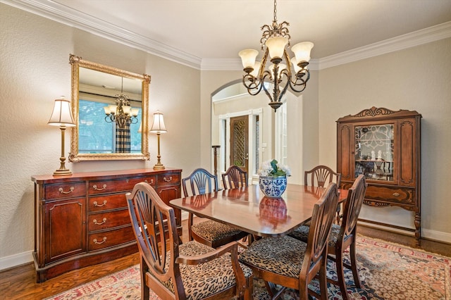 5222 Arcadia Glen Ln, Katy, TX 77494 - dining area with a chandelier, wood finished floors, ornamental molding, and arched walkways